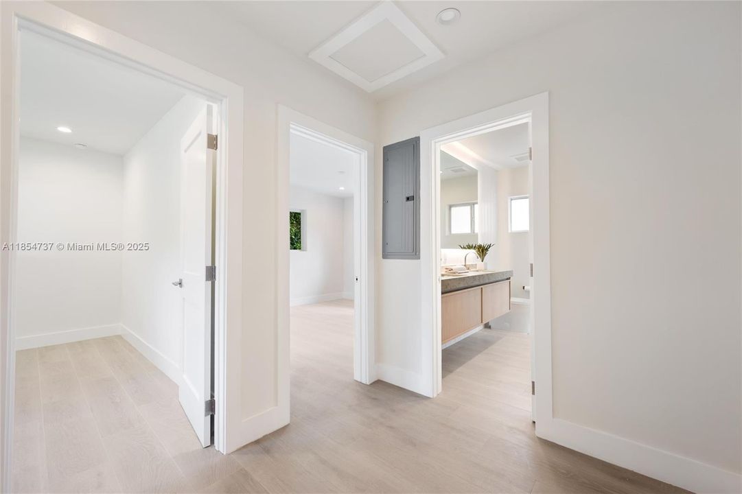 A cozy sitting area connects two bedrooms with a shared bathroom.