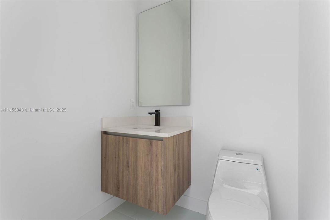 Cabana pool bathroom with A/C, sink, mirror, and toilet - no need to get into the home!