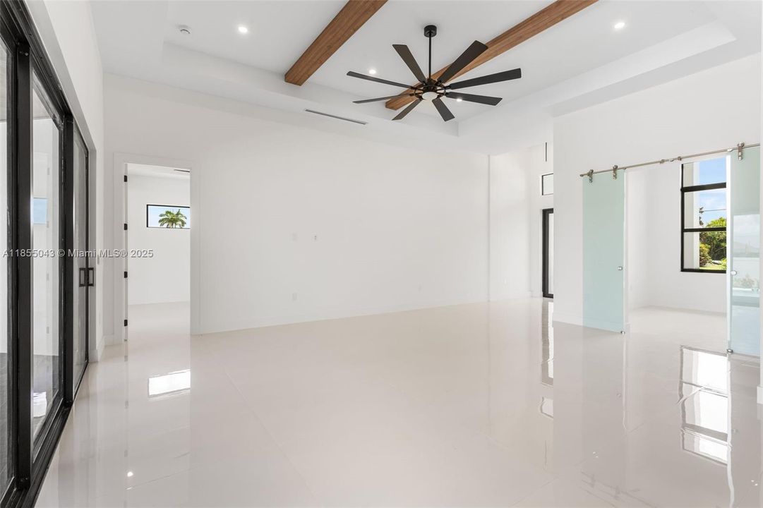 Exposed WOOD BEAMS and COVE CEILING add ARCHITECTURAL INTEREST and WARMTH, creating an ATMOSPHERE IDEAL FOR RELAXATION or HOSTING!