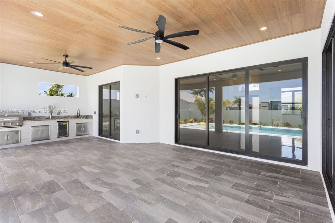 Covered lanai with flat wooden ceiling