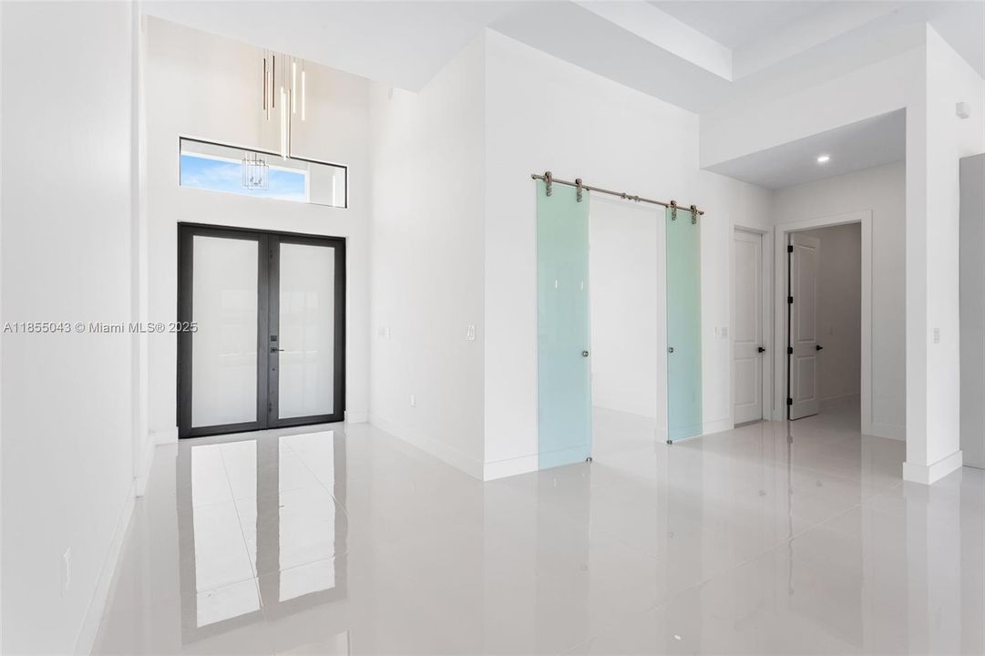 Enter through the COVERED FRONT PORCH and GRAND DOUBLE DOORS into a SOARING 16-FT FOYER, where a NEUTRAL PALETTE OF WHITE, LIGHT GRAY, and CASHMERE WELCOMES YOU HOME!