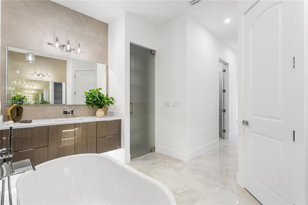 Custom vanities and mirrors, wall-mounted faucets, quartz countertops, under cabinet lights, linen closet, and an electric toilet for added convenience!