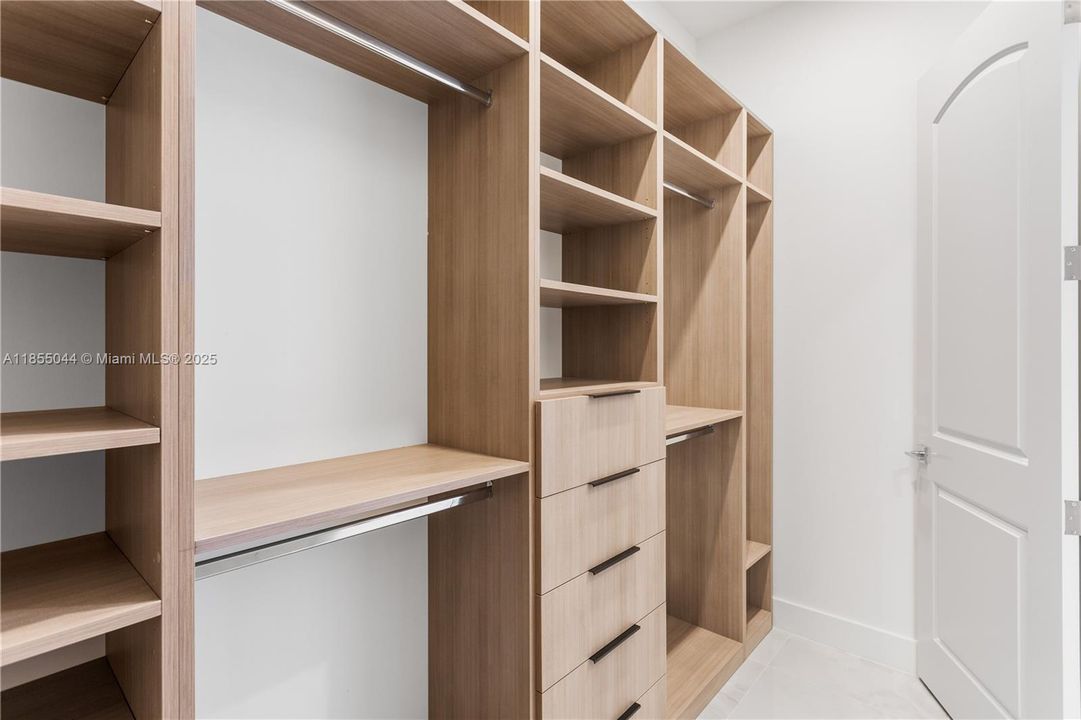 HIS and HERS WALK-IN CLOSETS, offering ample storage space for your wardrobe essentials.