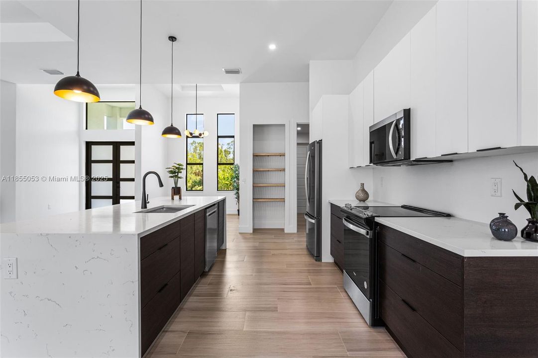 It features BLACK AND WHITE ITALIAN CABINETS & spacious QUARTZ WATERFALL ISLAND w/ BREAKSFAST BAR.