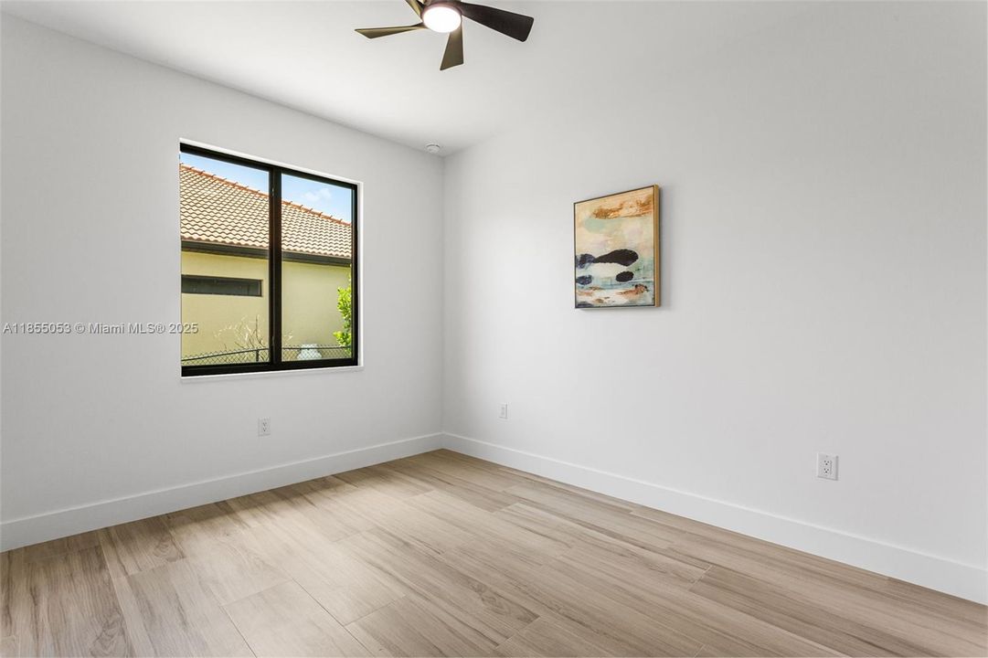 3rd Bedroom - One is located at the rear of the home, next to a POOL BATHROOM, while the other two are at the front, sharing a bathroom in hallway between them.