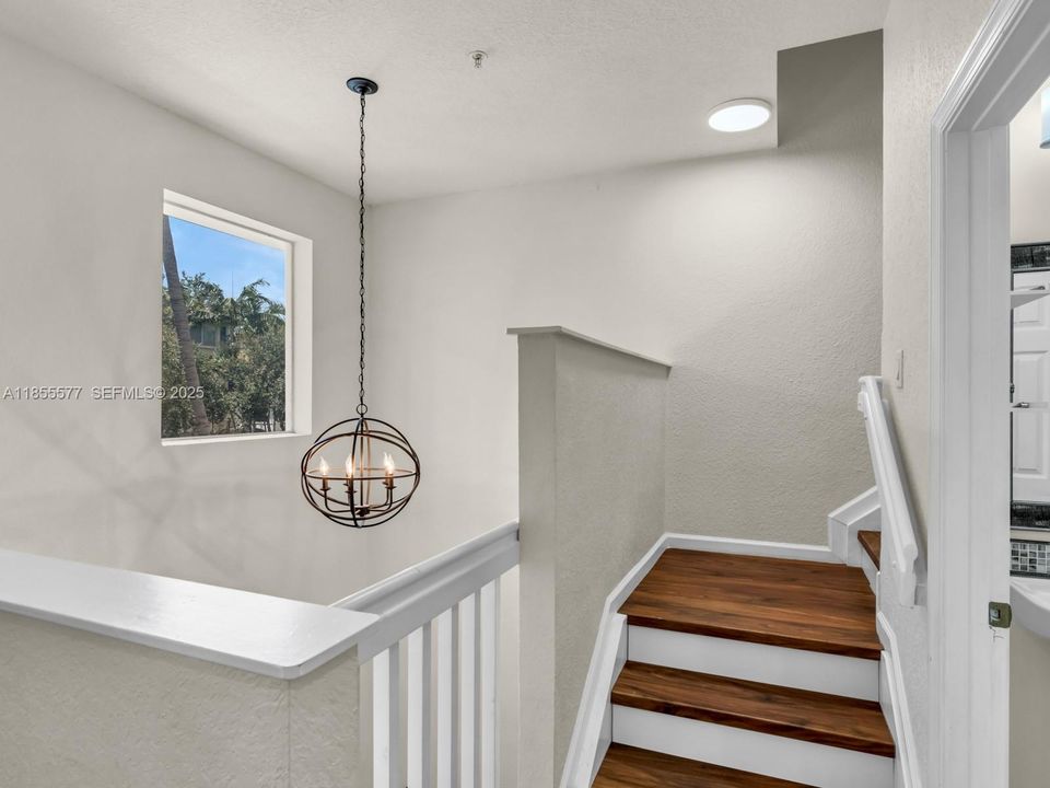 vaulted ceilings and modern light fixtures and tons of natural light