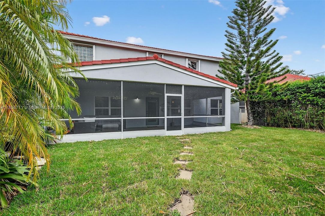 Private fenced yard with fire pit area, grilling area, mature landscaping, pond and waterfall.