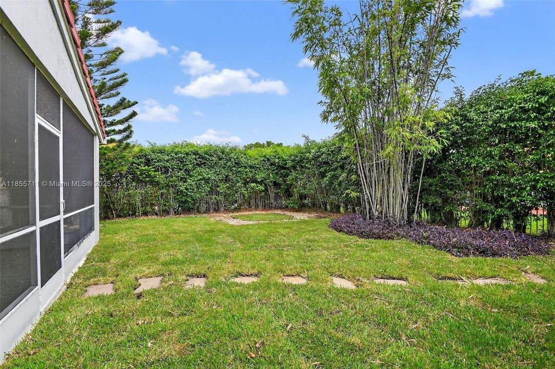 Private fenced yard with fire pit area, grilling area, mature landscaping, pond and waterfall.