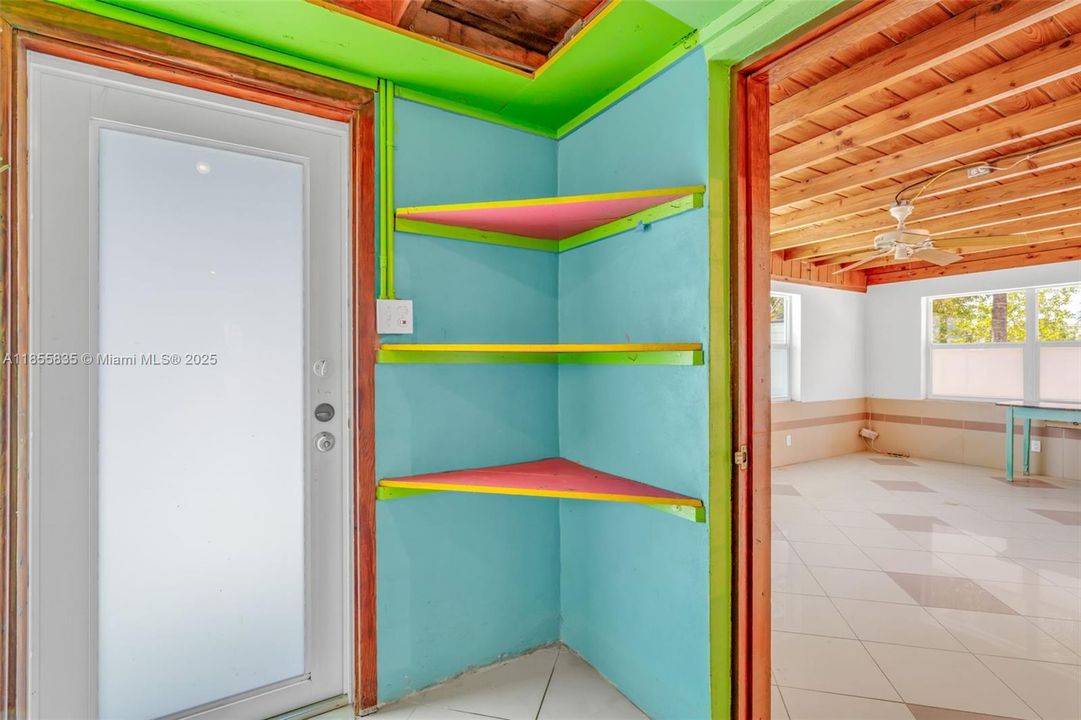 Storage shelves in laundry, exterior door to backyard dock area, would be convenient access to a future re-config to laundry room