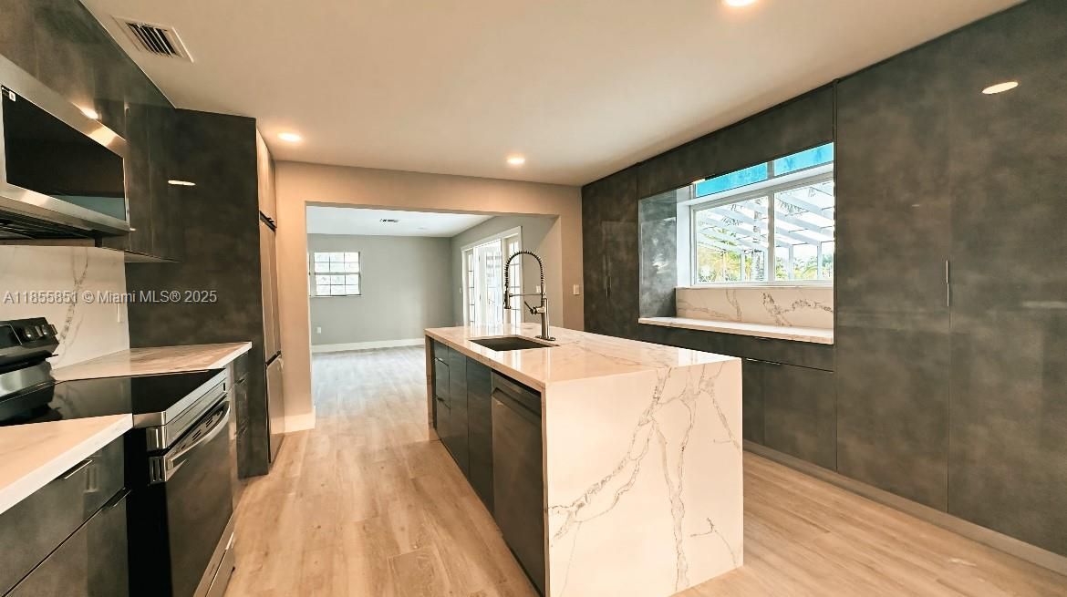 The pass through galleylike kitchen service both areas of family and dining, making entertaining convenient and seamless!