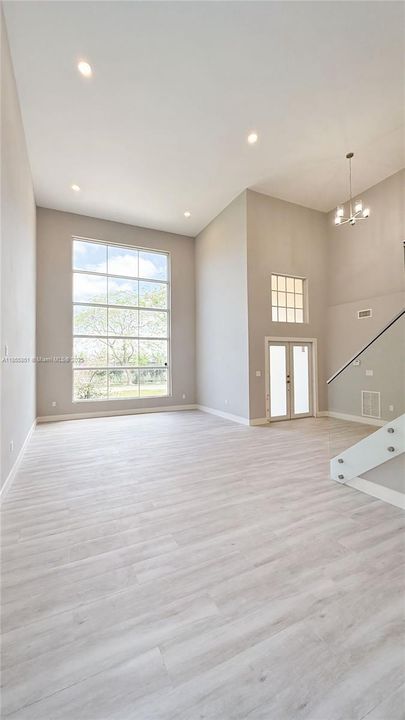 A full wall of windows welcome an abundance of natural light in the entry and living area, giving a light, open and airy comfort for serene relaxation.