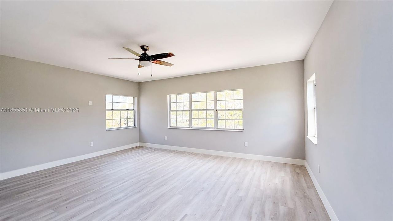 The spacious master bedroom overlooks the beautiful property, and is accompanied by the private ensuite master bath with double walk-in closets.