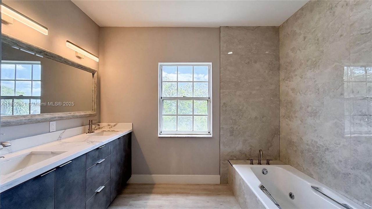 Modern elegance gives a luxurious spa like start to your day. Floor to ceiling tile, double sinks, and separate tub and shower.