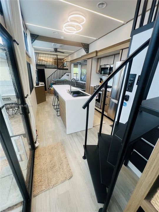 55” Hideaway Lift TV in Living RoomJBL Interior/Exterior Speaker SystemMotorized Shades in Living Area, Manual Shades in BedroomsCentral Vacuum SystemSoft-Close Drawers ThroughoutVinyl Flooring Throughout – Low Maintenance & Stylish2 Electric Fireplaces