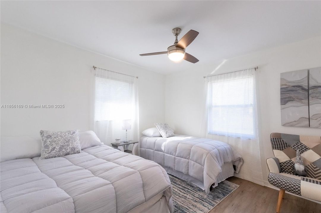 Corner guest bedroom overlooking the front yard