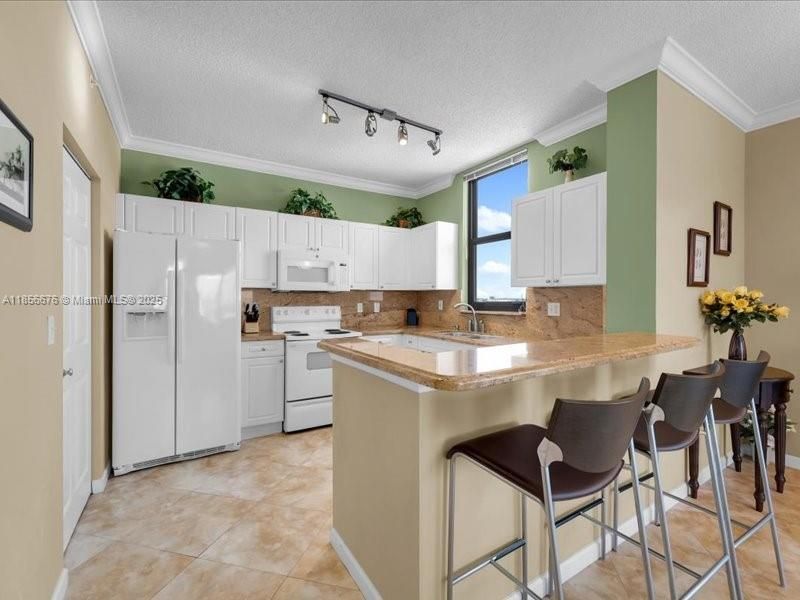 Open Kitchen and Counter-Dining Area. Perfect for hosting friends or family!651 Okeechobee Blvd., Unit #1002, West Palm Beach, FL.  City Place Tower Condominium. For Sale.