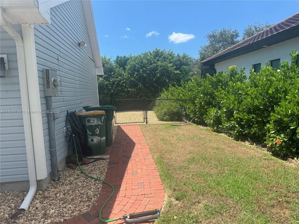 SIDE OF HOUSE LEADING TO BACK YARD