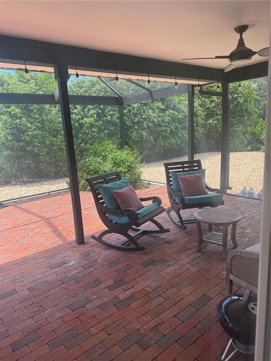 Florida Room leading to Lush fenced Backyard