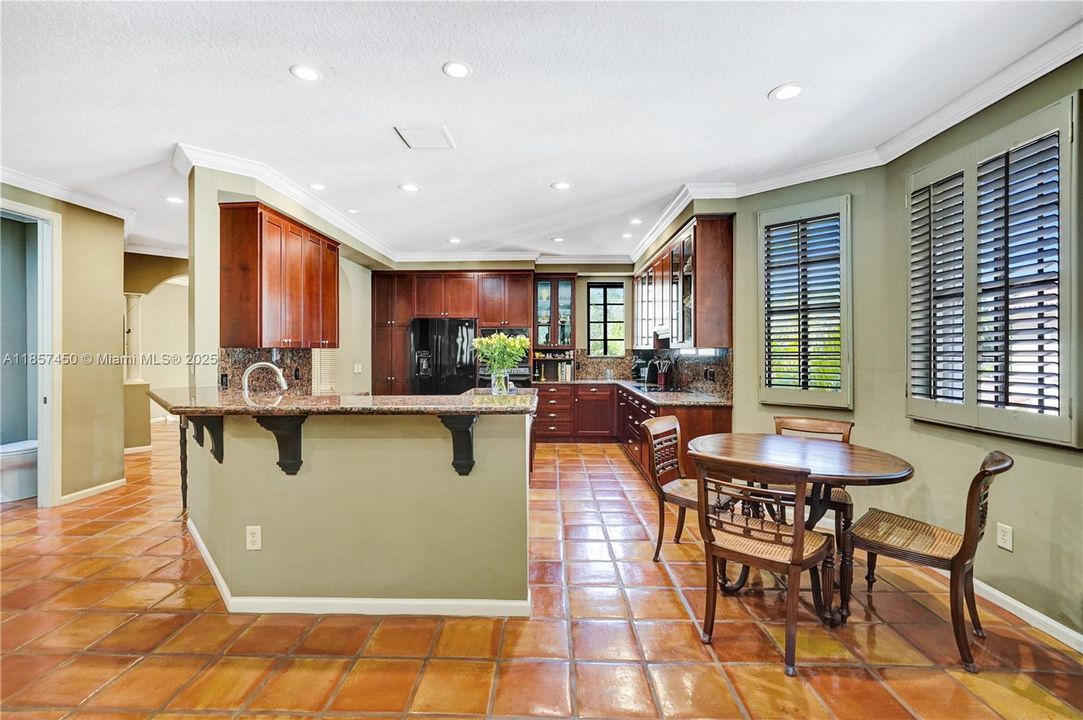 Large Kitchen with bar area and sun filled nook with a breakfast table
