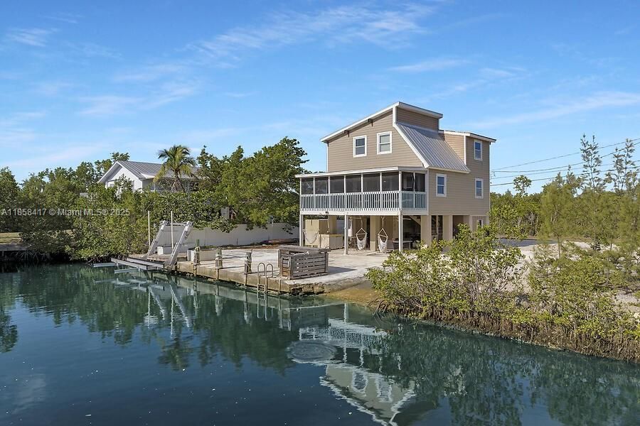 Charming property with boat ramp and boat lift for your boat.