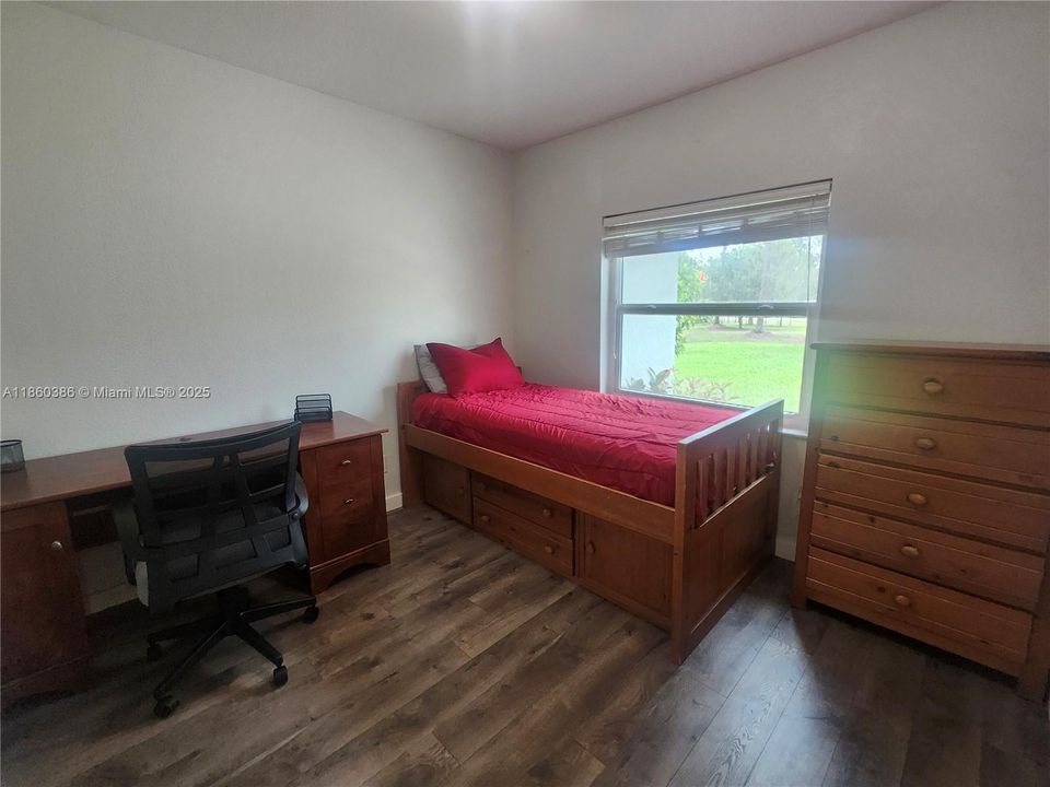 Den is currently being used as a bedroom.