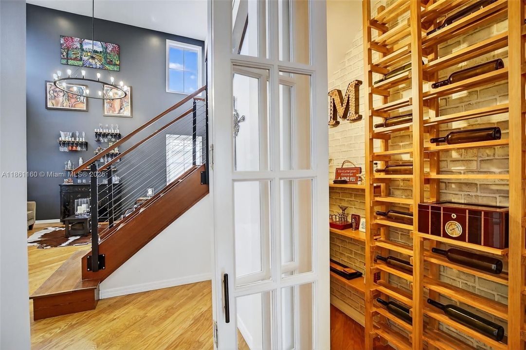 A thoughtful and clever use of space reveals a custom wine cellar under the stairs. This unique upgrade turns a typically utilitarian area into a stylish and functional showpiece, providing dedicated storage for your favorite vintages.