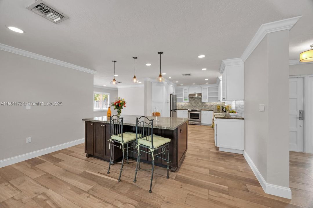 Kitchen with island. Stainless steel appliances