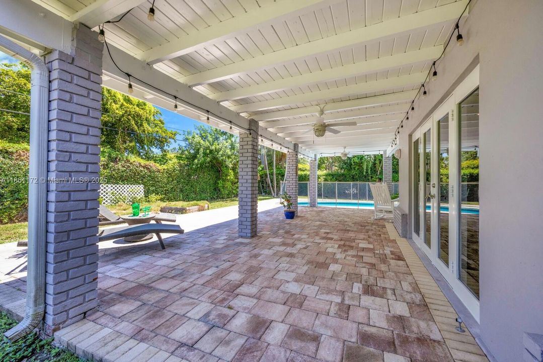 Covered, wrap around  L-shaped patio area