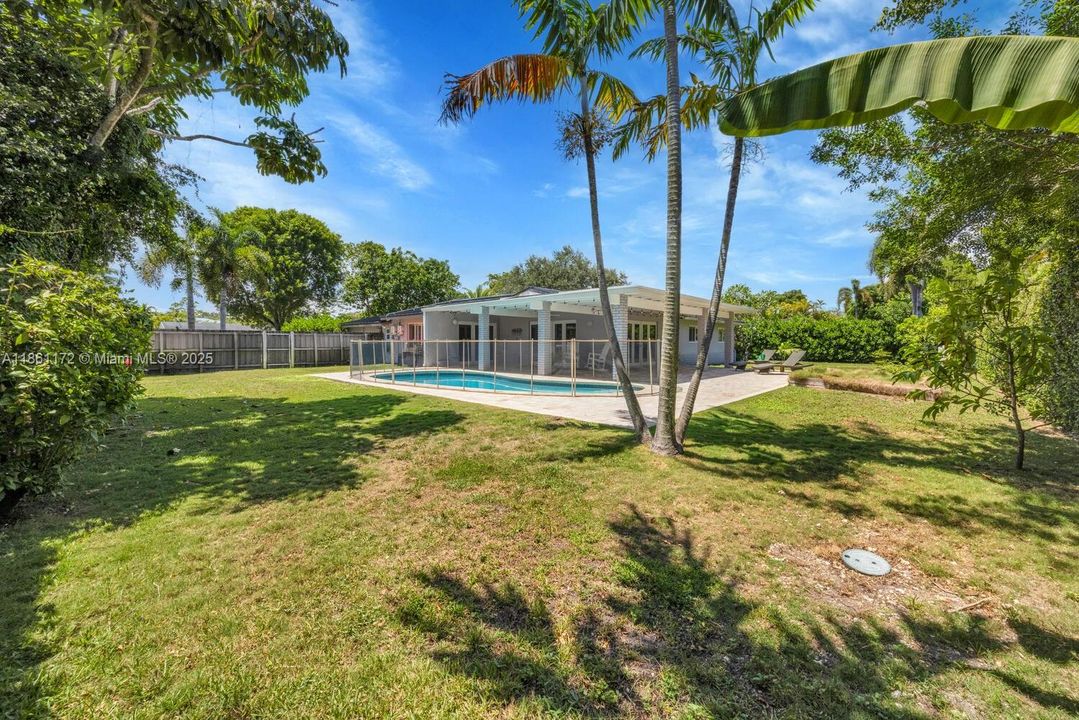 Fenced yard. Grassy play area. Trees & greenery