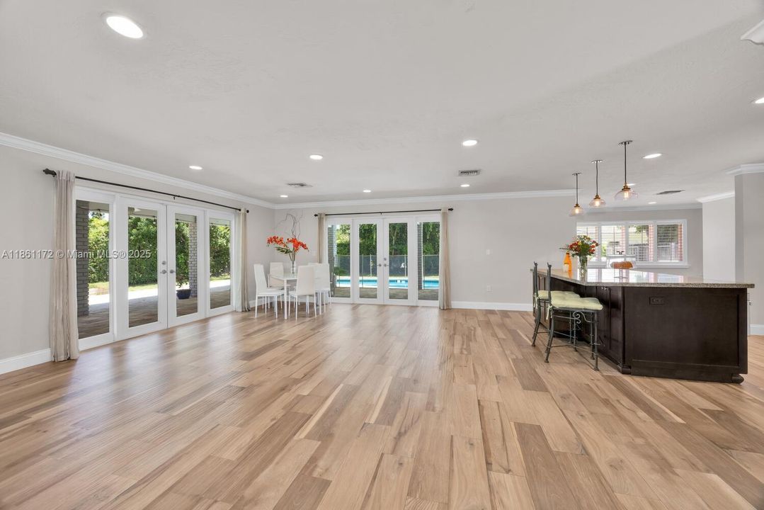French doors open to the pool patio. Light and airy