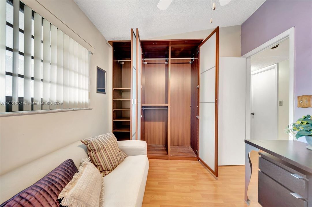 Versatile space ideal for work or guests, complete with ample closet storage.