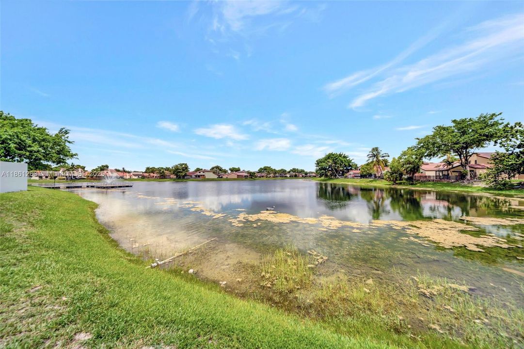 Peaceful community lake with walking views, water features, and plenty of open green space to relax by the water.