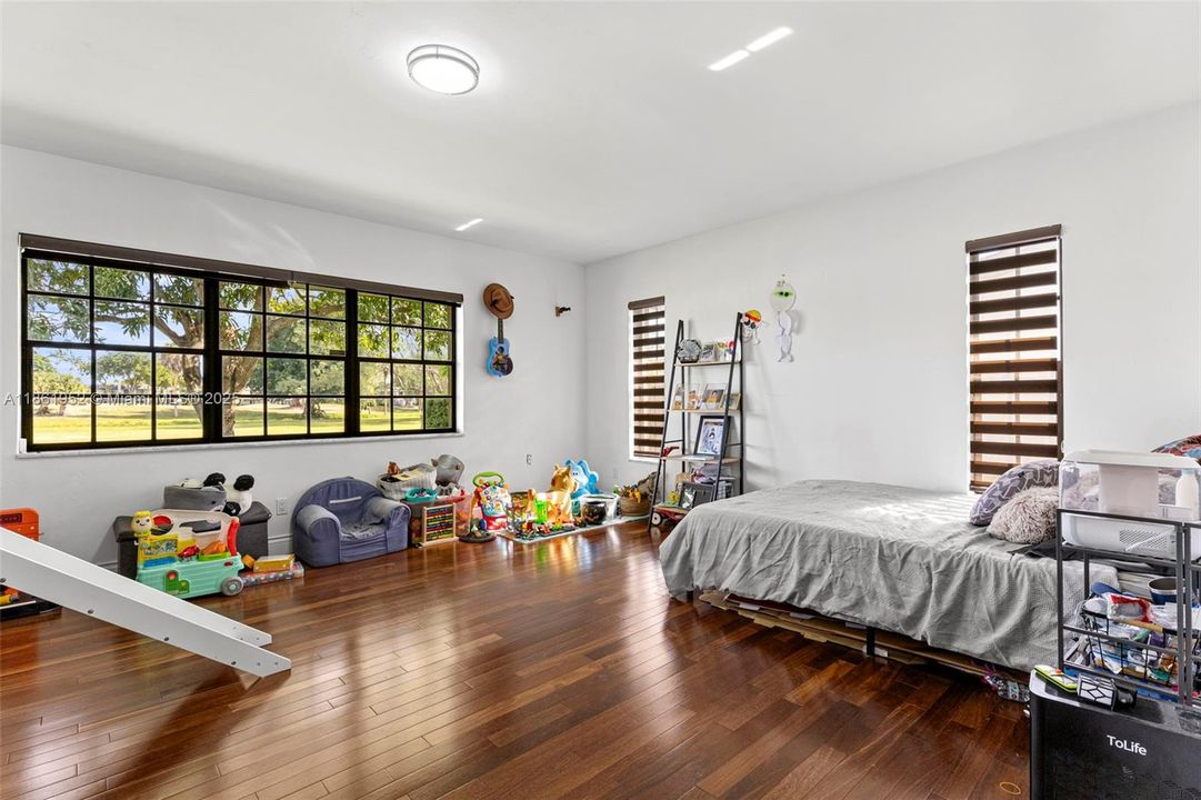 Large primary bedroom with beautiful golf course views.