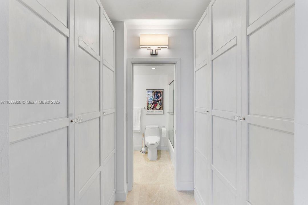 Hallway with custom Closets to full Bath