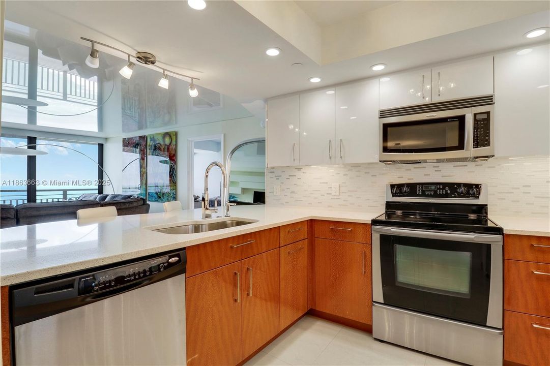 Gourmet open kitchen with custom Sycamore wood cabinetry