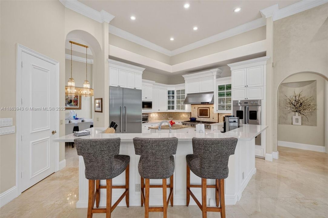 Gourmet kitchen with dual islands, Viking gas range, Thermador fridge, Miele dishwasher & custom cabinetry.