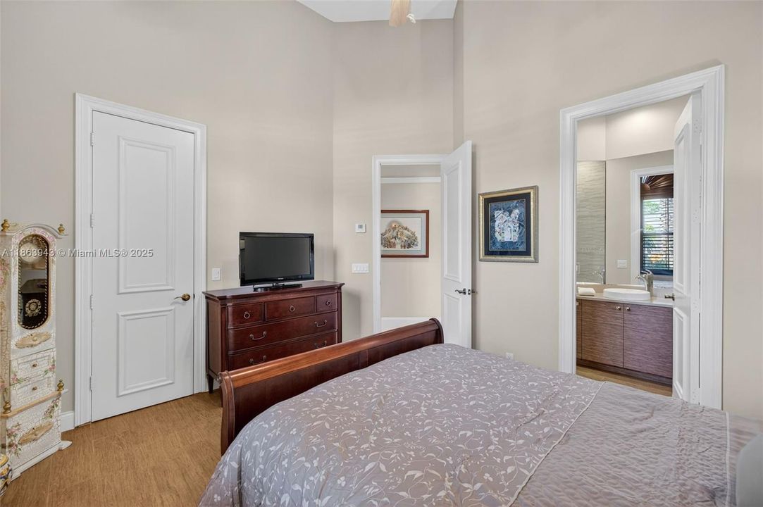 Guest bedroom located near the front of house w/ private ensuite bathroom, also has a walk in closet. Porcelain wood look flooring.
