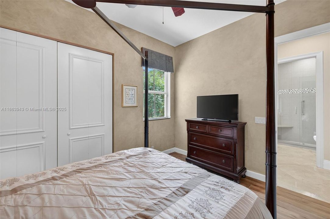 Guest bedroom w/ porcelain wood look flooring, located near the kitchen by itself. Full bathroom across the hall.