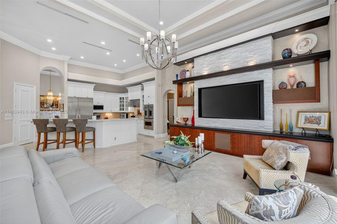 Expansive living area with coffered ceilings, crown molding, and designer details throughout.