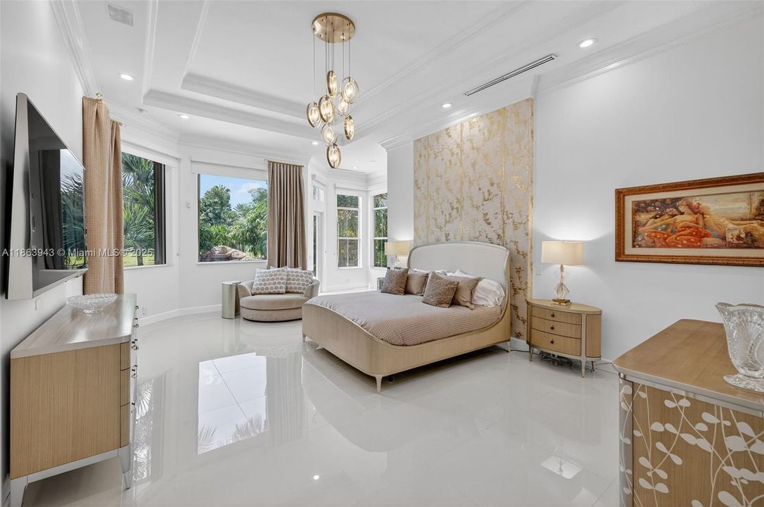 Spacious primary suite with dual custom walk-in closets.