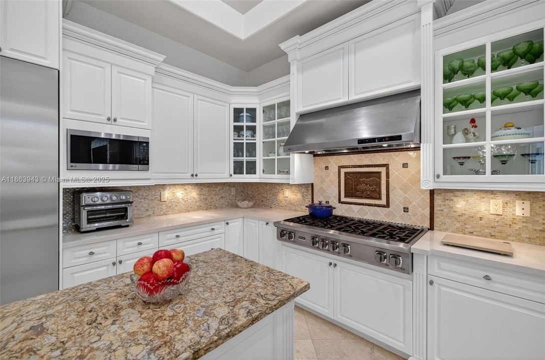 Gourmet kitchen with dual islands, Viking gas range, Thermador fridge, Miele dishwasher & custom cabinetry.