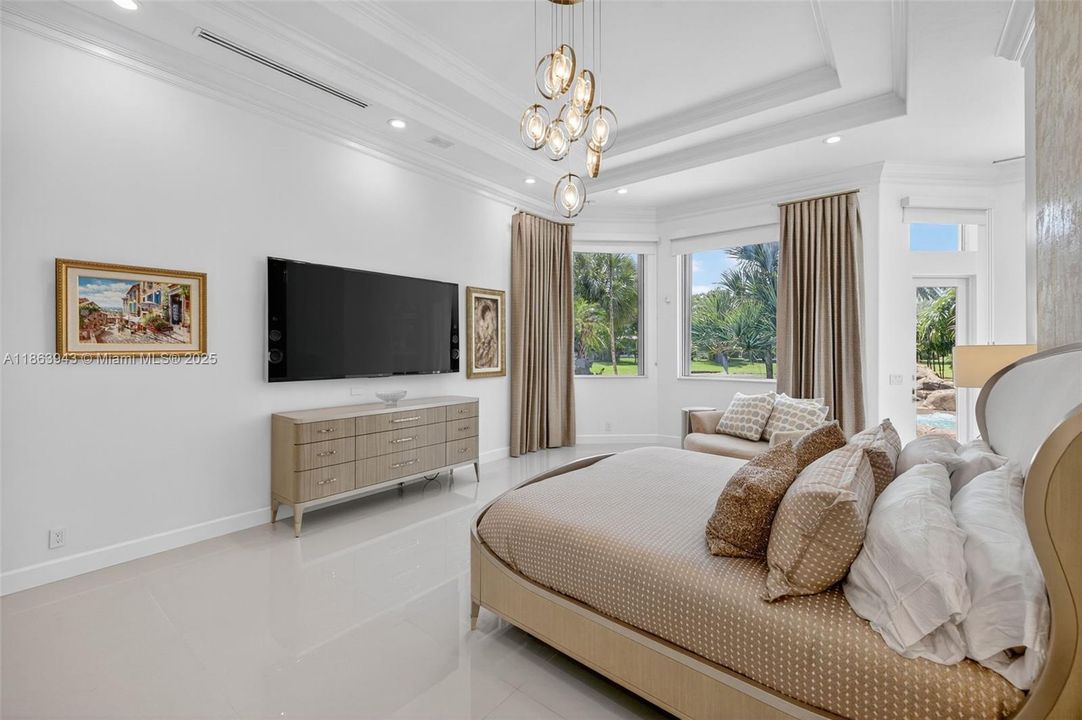 Spacious primary suite with dual custom walk-in closets.