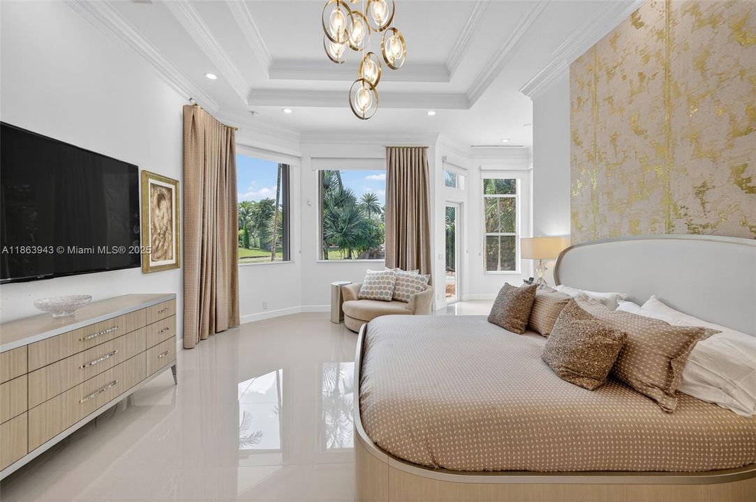 Spacious primary suite with dual custom walk-in closets.