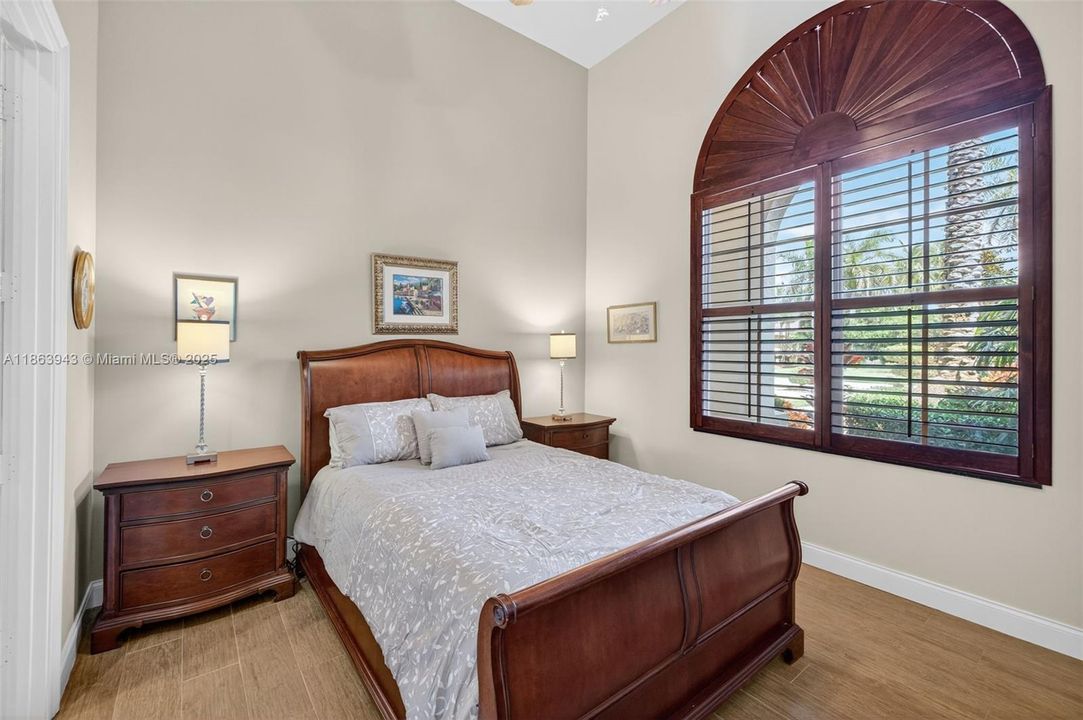 Guest bedroom located near the front of house w/ private ensuite bathroom, also has a walk in closet. Porcelain wood look flooring.