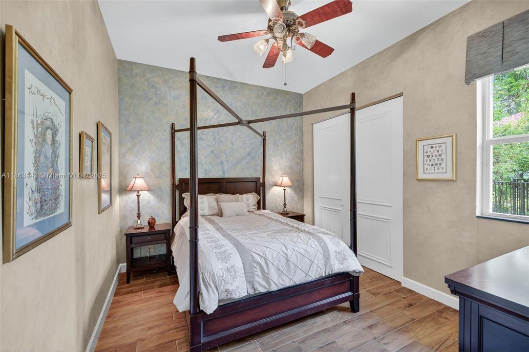 Guest bedroom w/ porcelain wood look flooring, located near the kitchen by itself. Full bathroom across the hall.