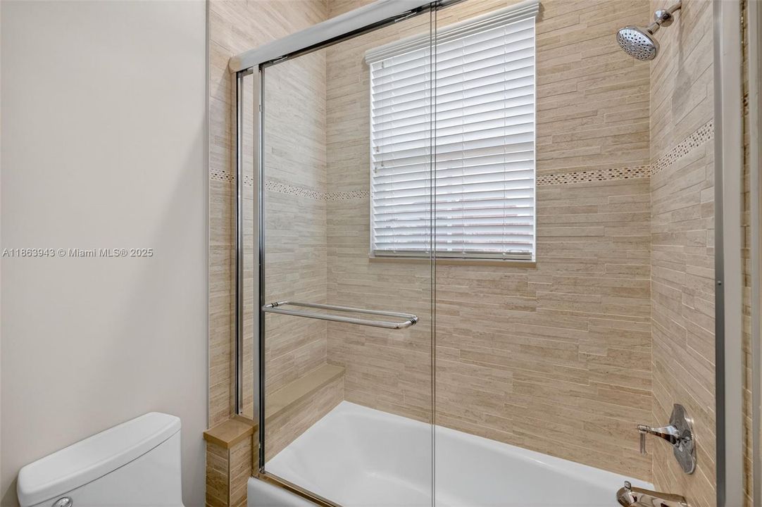 Gorgeous updated shared bathroom w/ double vanity and combination tub / shower. Designed by professional bathroom designer and contractor. Separate door for water closet / shower. tile goes to the ceiling