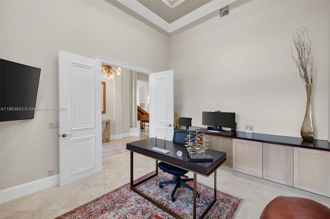 Custom office with built-in desk and credenza for a polished, productive space.