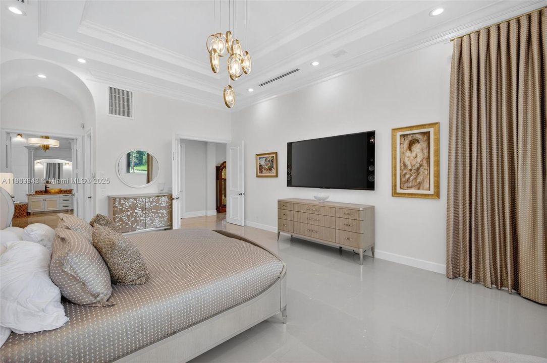 Spacious primary suite with dual custom walk-in closets.