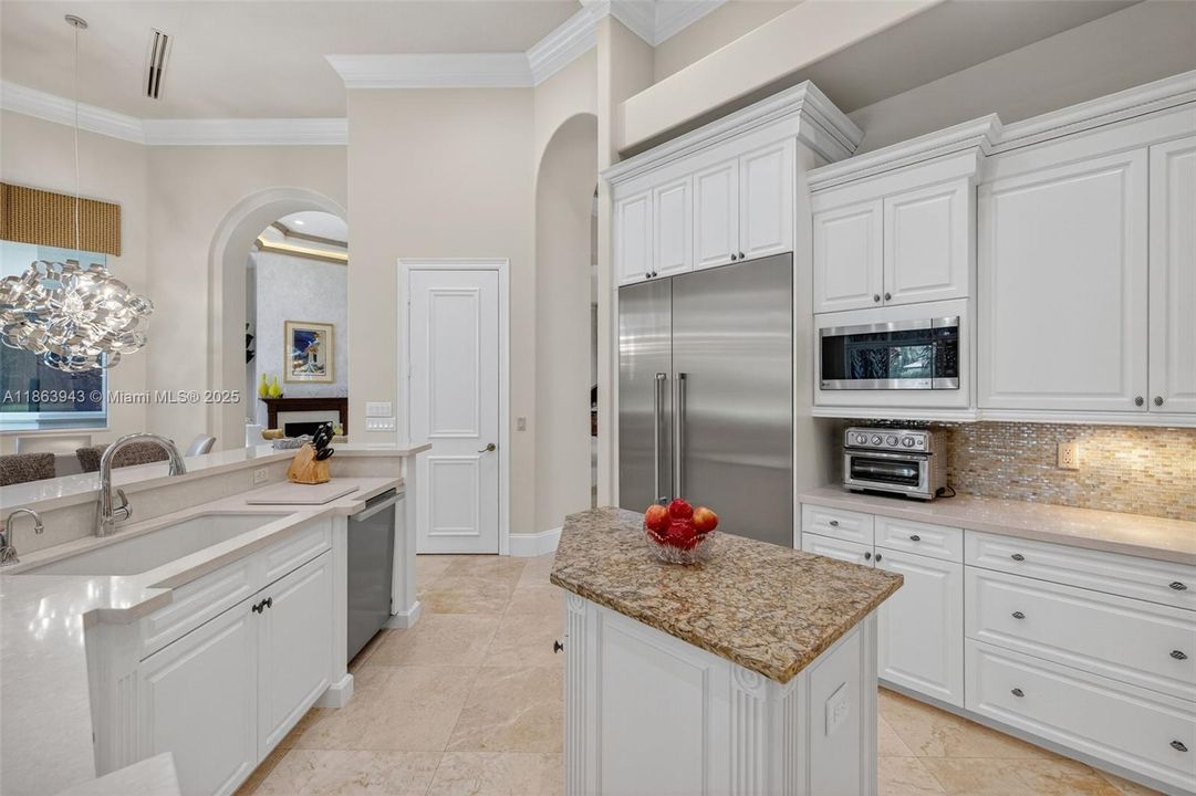 Gourmet kitchen with dual islands, Viking gas range, Thermador fridge, Miele dishwasher & custom cabinetry.