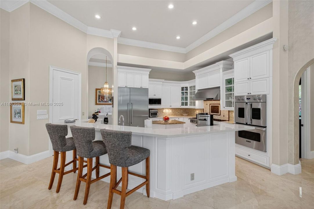Gourmet kitchen with dual islands, Viking gas range, Thermador fridge, Miele dishwasher & custom cabinetry.